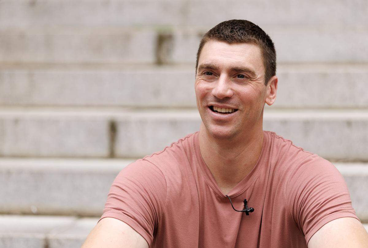 Former North Carolina basketball player Tyler Hansbrough smiles while speaking with media on Tuesday, Aug. 19, 2025, outside the UNC Hussman School of Journalism and Media in Chapel Hill, N.C. Hansbrough is co-teaching a sports communication course this semester with associate professor Livis Freeman. 