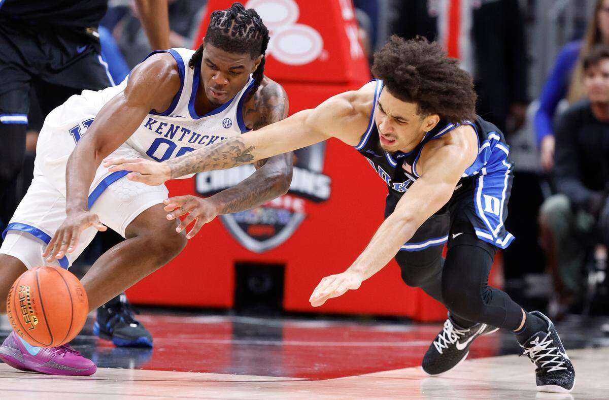 Duke’s Tyrese Proctor (5) dives after a ball controlled by Kentucky’s Otega Oweh (0) during the first half of Duke’s game against Kentucky in the State Farm Champions Classic in Atlanta, Ga., Tuesday, Nov. 12, 2024.