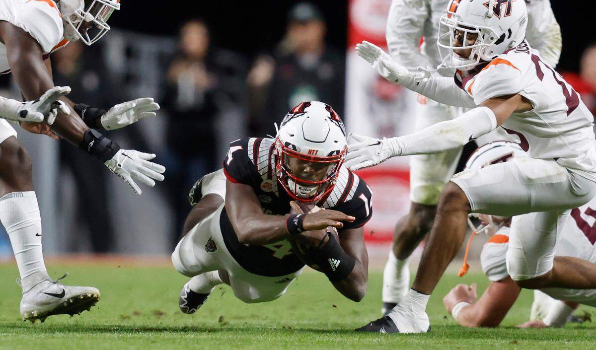 N.C. State quarterback Jack Chambers (14) dives for yards during the first half of N.C. State’s game against Virginia Tech at Carter-Finley Stadium in Raleigh, N.C., Thursday, Oct. 27, 2022.