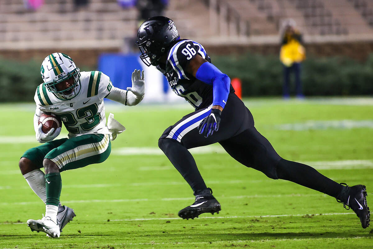 Charlotte 49ers wide receiver Micaleous Elder (23) runs with the ball while Duke Blue Devils defensive end Chris Rumph II (96) chases him during the first half at Wallace Wade Stadium.