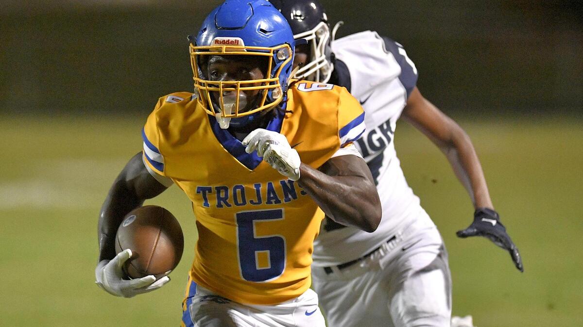 Garner’s Isaiah Dawson (6) runs for the touchdown during the first half. The Garner Trojans and the Southeast Raleigh Bulldogs met in a conference football game in Garner, N.C, on October 6, 2023