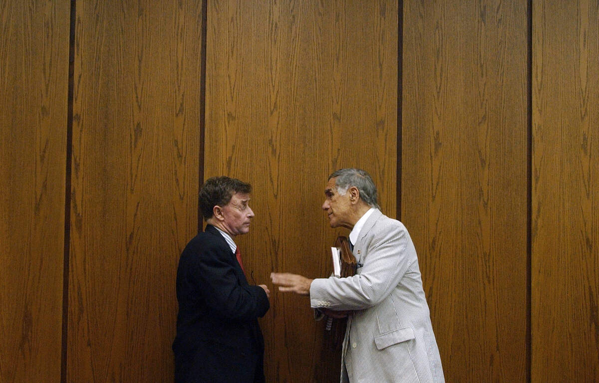 Michael Peterson (at left) speaks with friend and supporter Nick Galifianakis Monday July 28,2003 as Peterson’s murder trial started it’s fifth week. Peterson is on trial in connection with the death of his wife Kathleen Peterson.