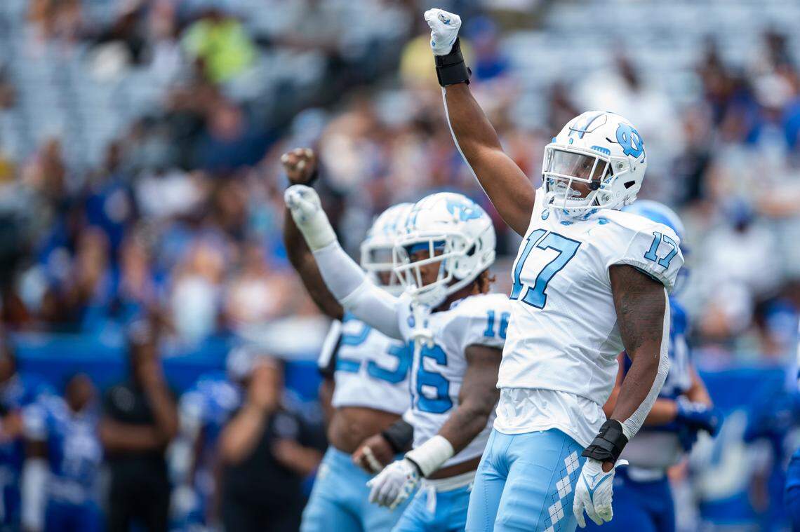 North Carolina linebacker Chris Collins left, and defensive back DeAndre Boykins middle, and linebacker Power Echols gestures fourth down in the second half of an NCAA college football game against Georgia State Saturday, Sept. 10, 2022, in Atlanta.