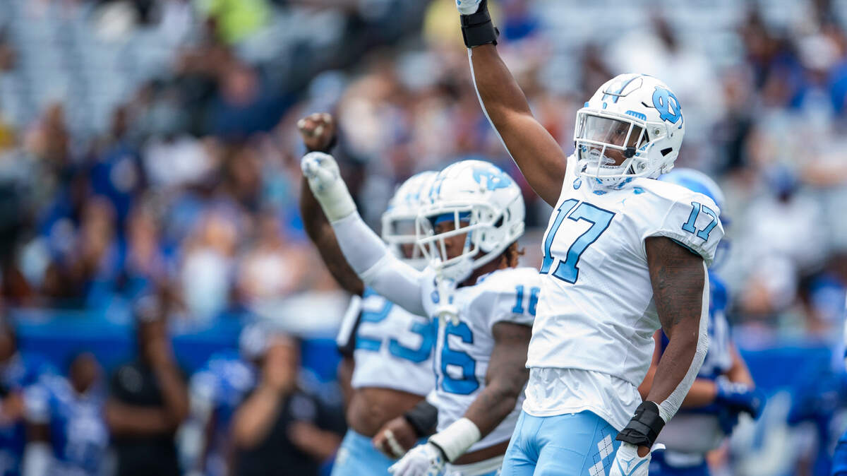 North Carolina linebacker Chris Collins left, and defensive back DeAndre Boykins middle, and linebacker Power Echols gestures fourth down in the second half of an NCAA college football game against Georgia State Saturday, Sept. 10, 2022, in Atlanta.