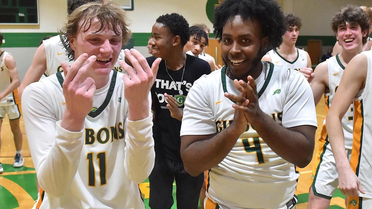 Cardinal Gibbons’ Ronny Turner (11) and Xavier Deberry (4) celebrate after their defeat of Sanderson. The Sanderson Spartans and the Cardinal Gibbons Crusaders met in a regular season basketball game in Raleigh, N.C. on February 10, 2023.