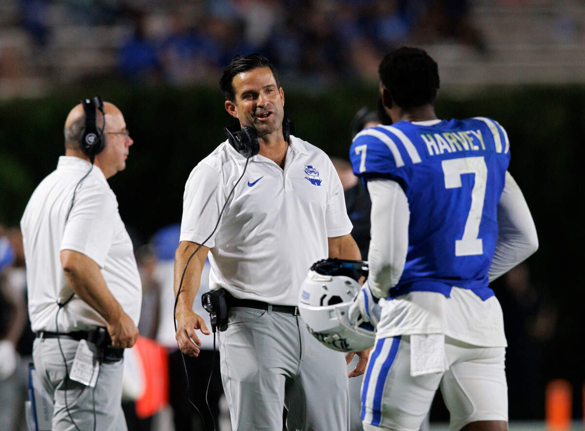 Duke head coach Manny Diaz speaks with Javon Harvey during the second half of the Blue Devils’ 26-3 win over Elon on Friday, Aug. 30, 2024, at Wallace Wade Stadium in Durham, N.C.