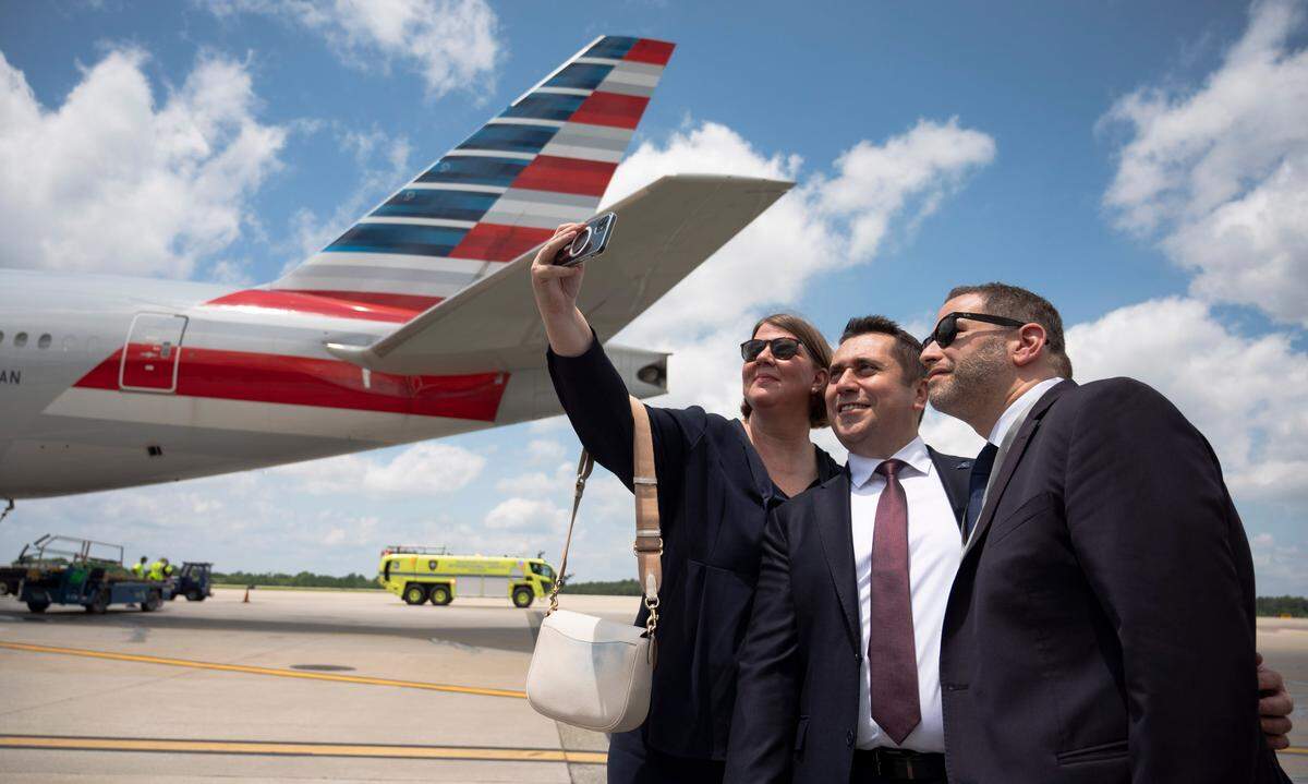 Lufthansa employees take a selfie as the airline’s first flight from Frankfurt, Germany, arrives at the Raleigh-Durham International Airport on June 6, 2024.
