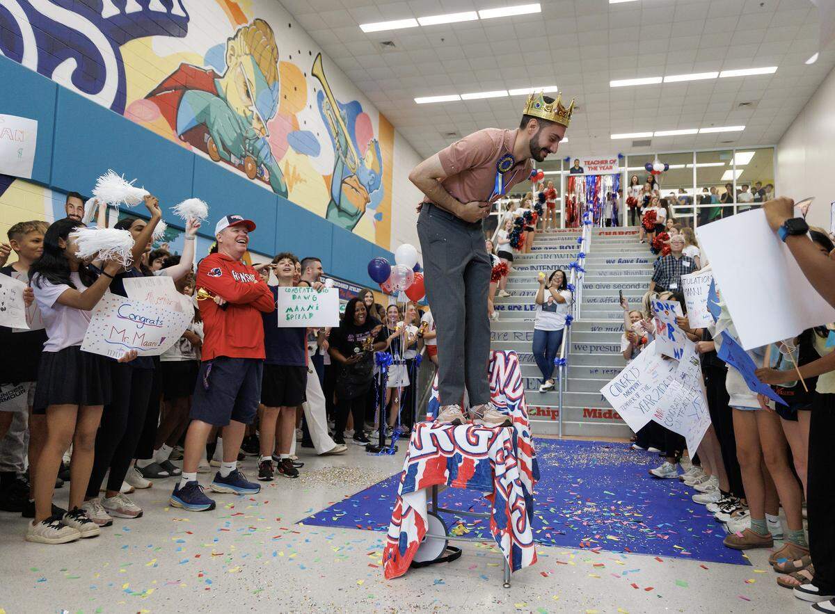 Matin Maani, a seventh-grade social studies teacher at Apex Friendship Middle School, takes a bow during a celebration recognizing him as the 2026 Wake County Teacher of the Year on Thursday, May 21, 2026, in Apex, N.C. 
