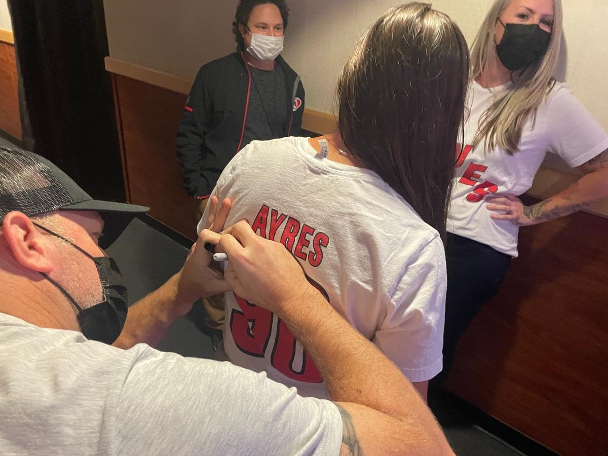 David Ayres signs a fan’s shirt before sounding the Carolina Hurricanes warning siren Monday, October 25, 2021, at PNC Arena before the Hurricanes played the Toronto Maple Leafs.