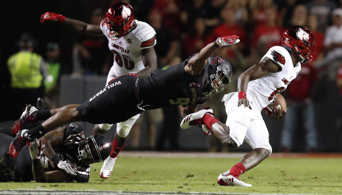 N.C. State defensive end Bradley Chubb (9) tackles Louisville quarterback Lamar Jackson (8) during the first half of N.C. State’s game against Louisville at Carter-Finley Stadium in Raleigh, NC Thursday, Oct. 5, 2017.