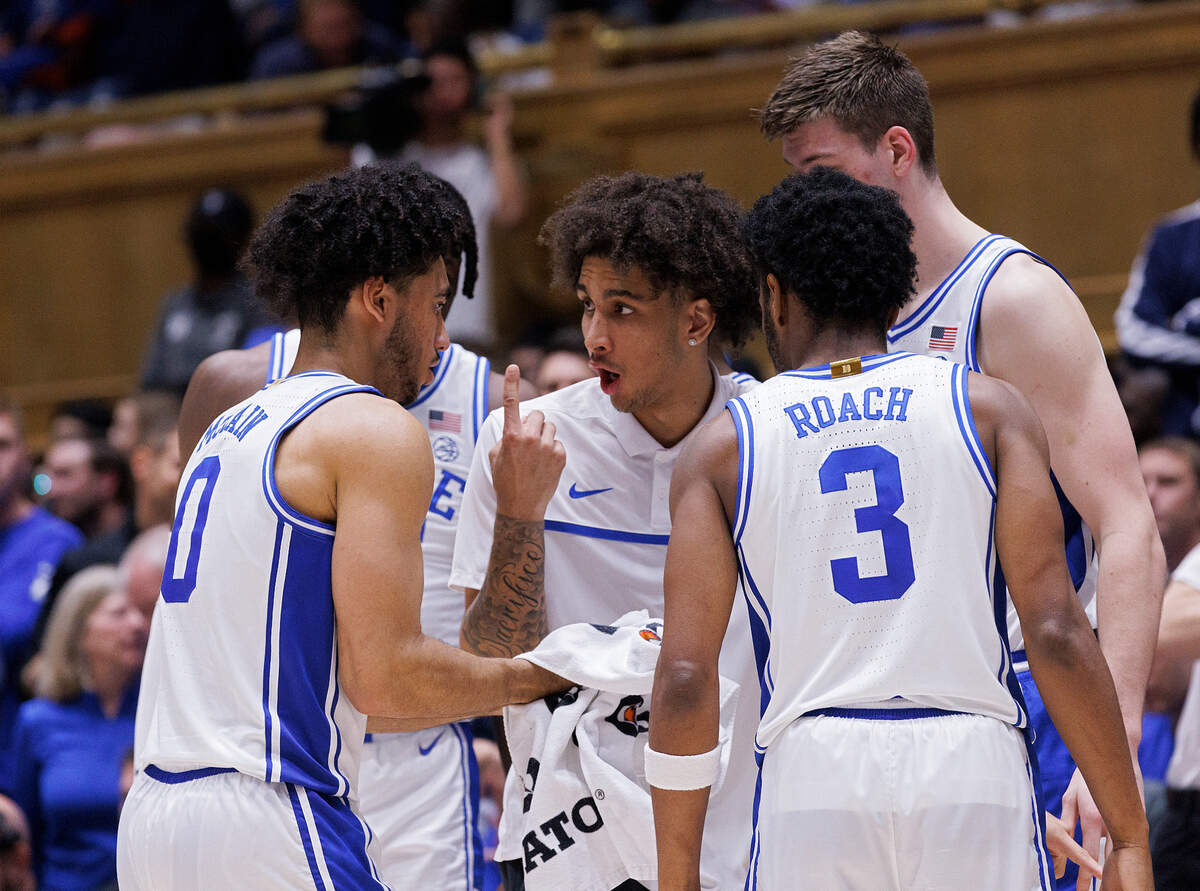 Duke’s Tyrese Proctor, center, sidelined due to a sprained ankle, gives instructions to his teammates during the second half of the Blue Devils’ 89-68 win over Hofstra on Tuesday, Dec. 12, 2023, at Cameron Indoor Stadium in Durham, N.C.