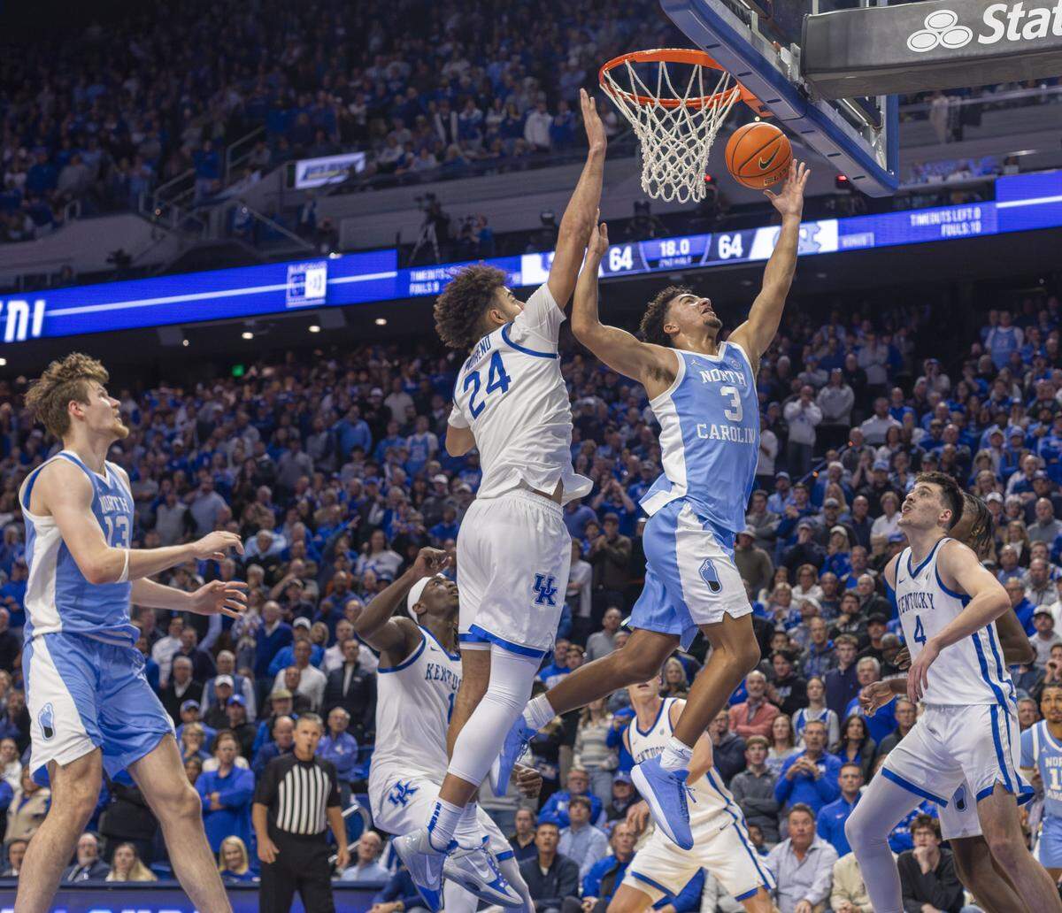 North Carolina guard Derek Dixon (3) scores the game winning basket with 16 seconds to play against Kentucky center Malachi Moreno (24) on Tuesday, December 2, 2025 at Rupp Arena in Lexington, Ky.