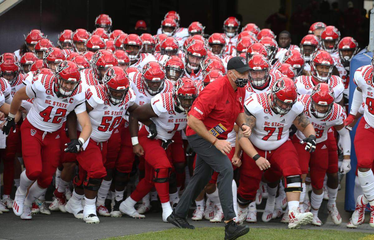 N.C. State coach Dave Doeren leads the team onto the field before the game against the Pittsburgh Panthers at Heinz Field.