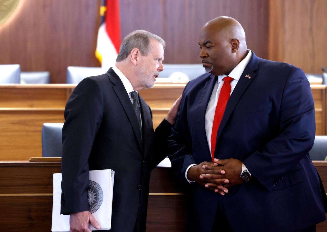 Senate Leader Phil Berger, left, talks with Lt. Gov. Mark Robinson during a press conference in Raleigh on Aug. 24, 2021. The press conference was to talk about House Bill 324 which limits how teachers can discuss certain racial concepts in the classroom. The bill passed along party lines.
