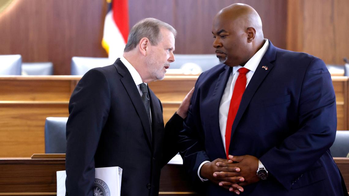 Senate Leader Phil Berger, left, talks with Lt. Gov. Mark Robinson during a press conference in Raleigh on Aug. 24, 2021. The press conference was to talk about House Bill 324 which limits how teachers can discuss certain racial concepts in the classroom. The bill passed along party lines.