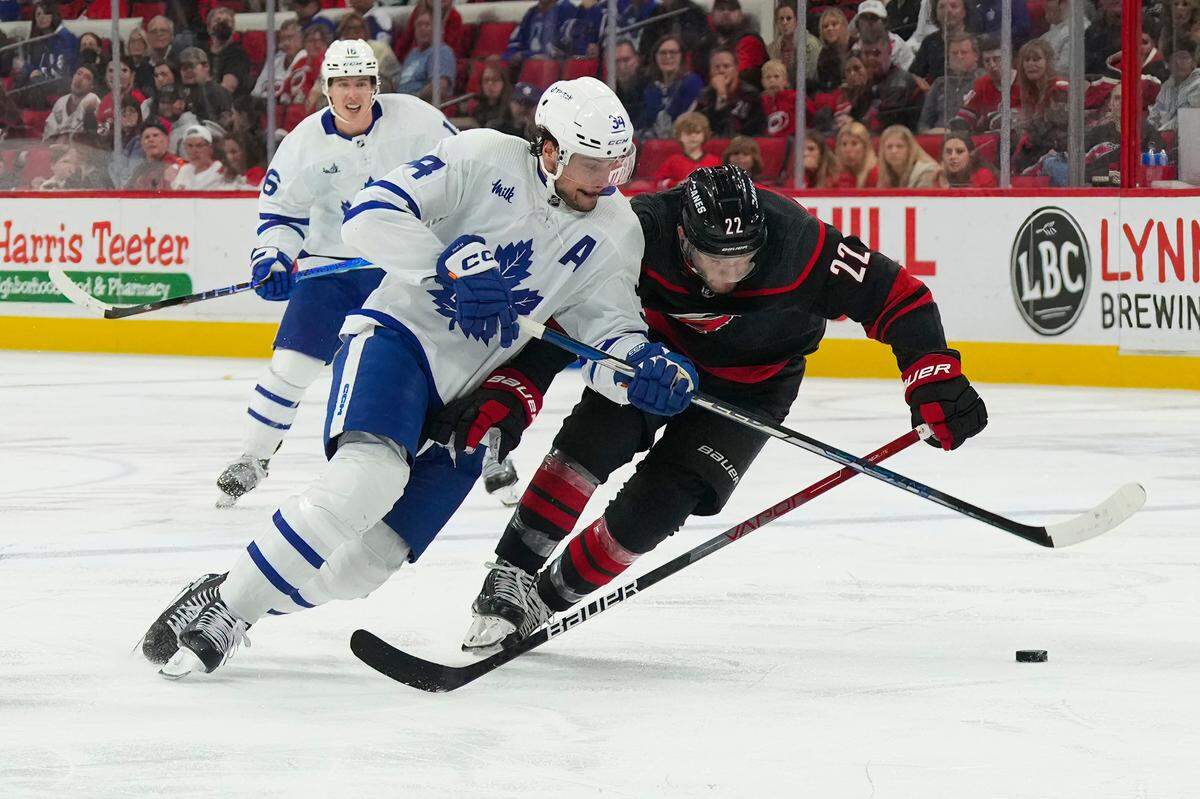 Toronto Maple Leafs center Auston Matthews (34) skates after the puck against Carolina Hurricanes defenseman Brett Pesce (22) during the second period at PNC Arena.