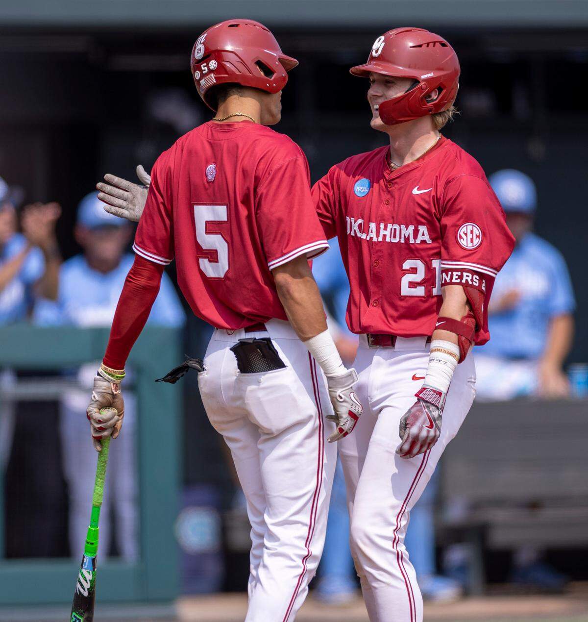 Oklahoma third baseman Dawson Willis (5) greets designated hitter Drew Dickerson (21) at home plate after Dickerson connected for a two run homer in the second inning against North Carolina during Game 7 of the NCAA Chapel Hill Regional on Monday, June 2, 2025 at Boshamer Stadium in Chapel Hill, N.C.