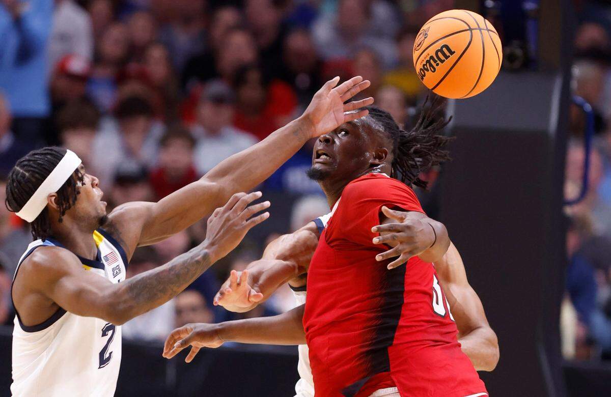 N.C. State’s DJ Burns Jr. (30) loses the ball as Marquette’s Chase Ross (2) defends during the first half of N.C. State’s game against Marquette in their NCAA Tournament Sweet 16 game at the American Airlines Center in Dallas, Texas, Friday, March 29, 2024.