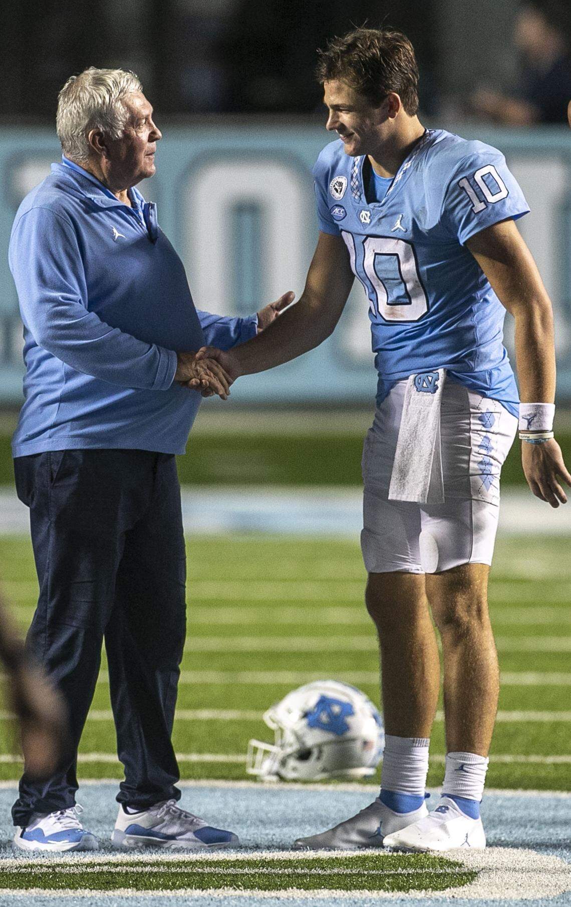North Carolina coach Mack Brown congratulates quarterback Drake Maye (10) following the Tar Heels’ 56-24 victory over Florida A&M on Saturday, August 27, 2022 at Kenan Stadium in Chapel Hill, N.C. Maye passed for 294 yards and five touchdowns in the victory.
