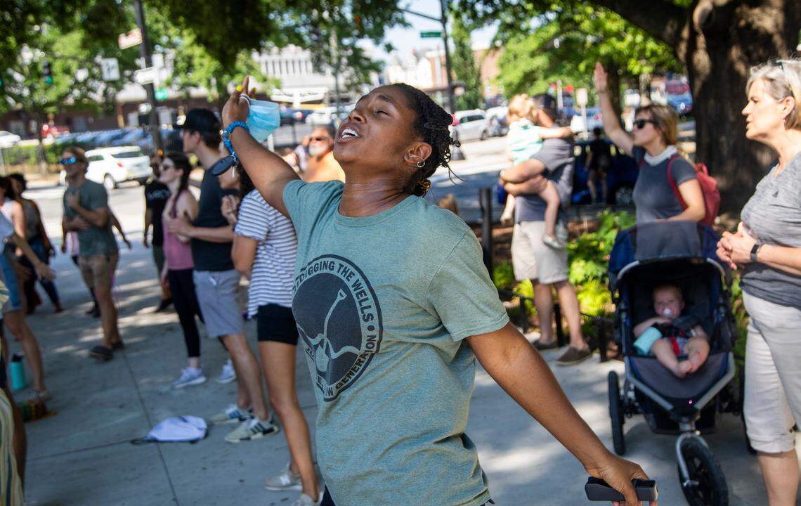 Janae Carlee of Raleigh sings with with a group of Christians in MooreÕs Square as protest groups demonstrated in downtown Raleigh Wednesday, June 3, 2020.