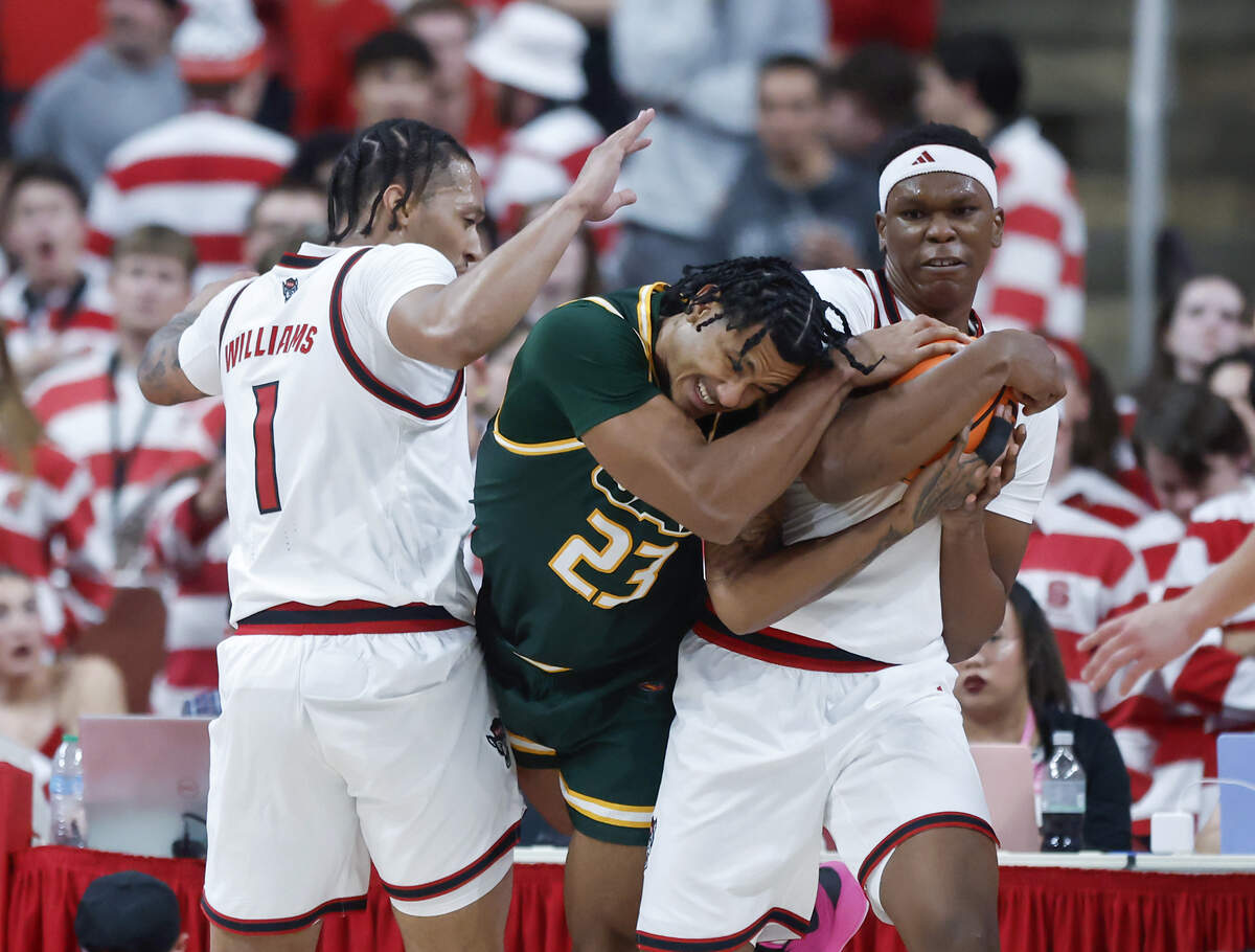 N.C. State’s Darrion Williams and Ven-Allen Lubin wrestle the ball away from UAB’s Daniel Rivera during the second half of the Wolfpack’s 94-70 win at Lenovo Center on Friday, Nov. 7, 2025, in Raleigh, North Carolina.