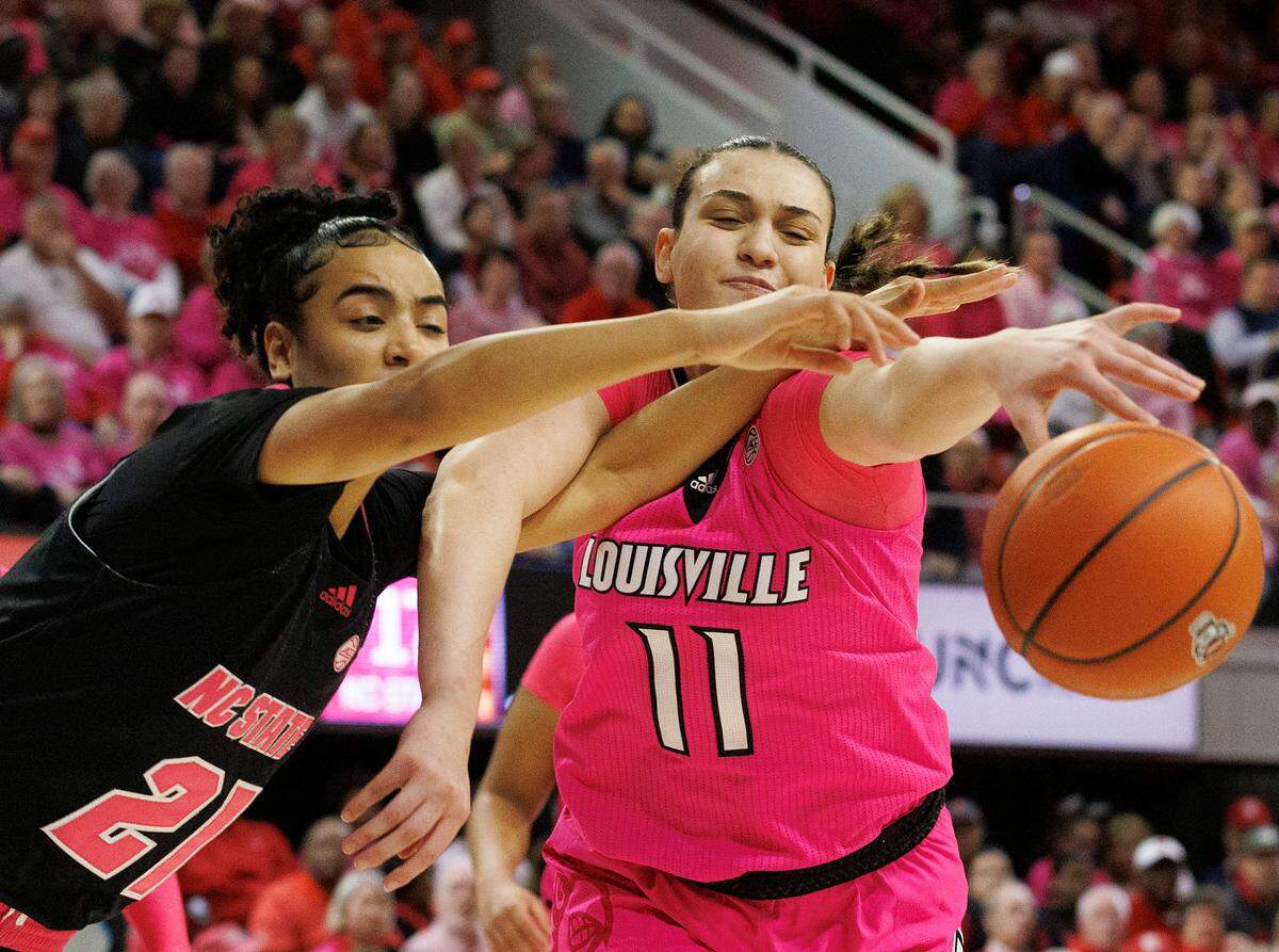 N.C. State’s Madison Hayes and Louisville’s Elif Istanbulluoglu lunge for a loose ball during the first half of the Wolfpack’s 77-67 win on Monday, Feb. 5, 2024, at Reynolds Coliseum in Raleigh, N.C.