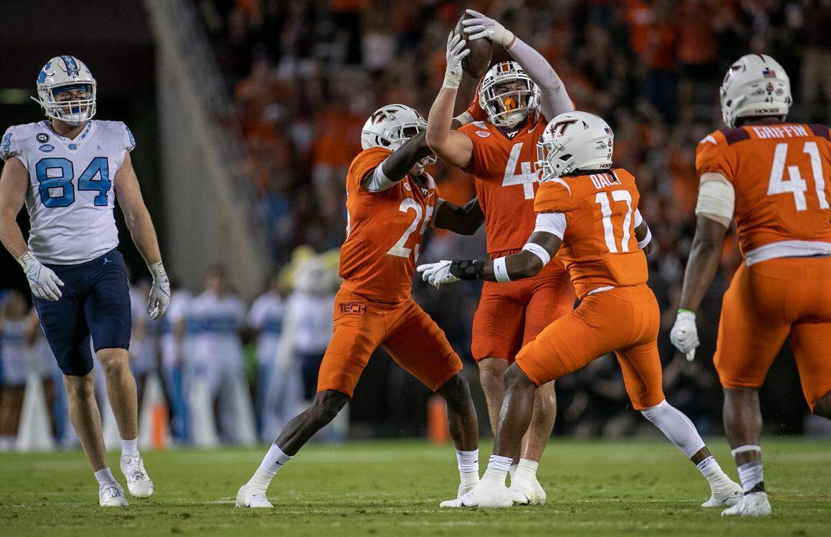 Virginia Tech’s Dax Hollifield (4) celebrates after intercepting North Carolina quarterback Sam Howell in the fourth quarter on Friday, September 3, 2021 at Lane Stadium in Blacksburg, Va.