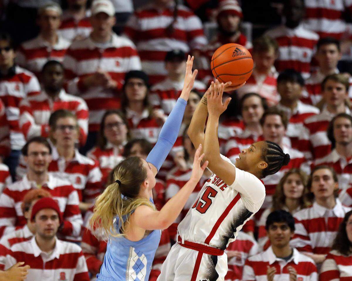 N.C. State’s Zoe Brooks shoots over North Carolina’s Alyssa Ustby during the first half of the Wolfpack’s 63-59 win on Thursday, Feb. 1, 2024, at Reynolds Coliseum in Raleigh, N.C.