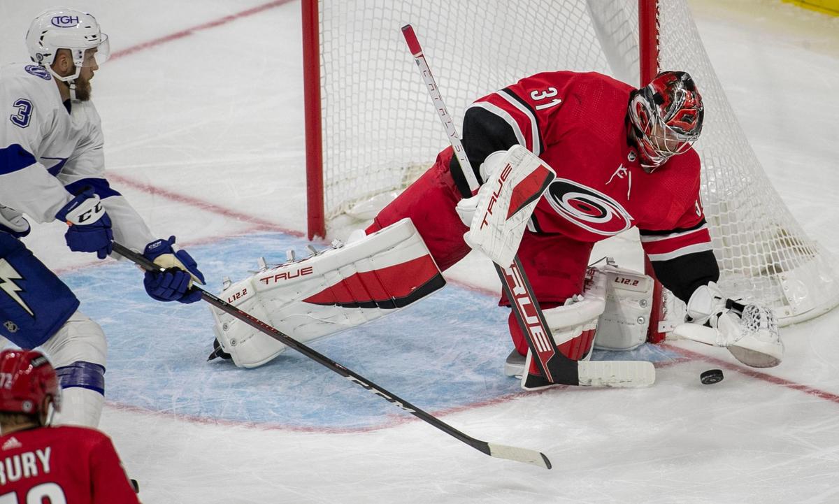 Carolina Hurricanes goalie Frederik Andersen (31) stops a shot by Tampa Bay’s Fredrik Claesson (3) in the third period of their NHL exhibition game on Tuesday, September 28, 2021 at PNC Arena in Raleigh, N.C.