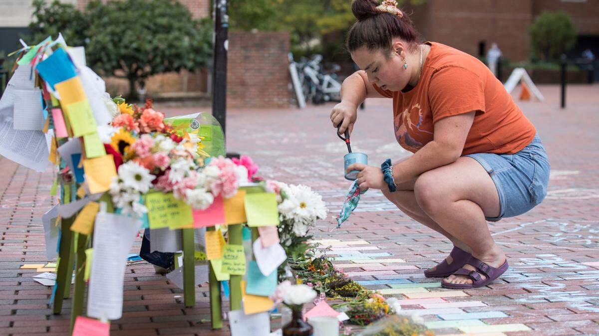 UNC-Chapel Hill senior Christie Scialabba lights a candle Oct. 12, 2021 at a memorial for students who reportedly died by suicide.