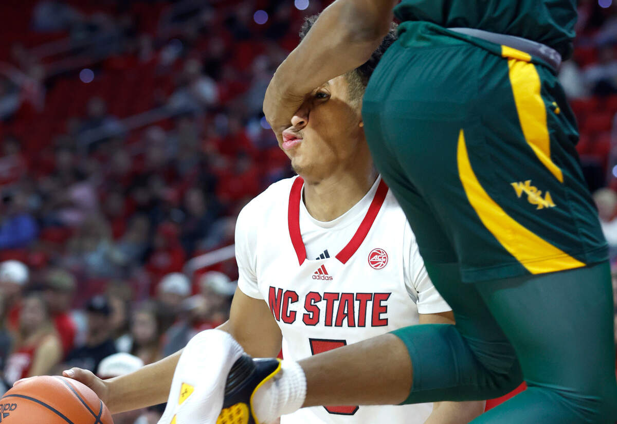William & Mary’s Chase Lowe (2) fouls N.C. State’s Jack Clark (5) during the first half of N.C. State’s game against William & Mary at PNC Arena in Raleigh, N.C., Tuesday, Nov. 29, 2022.
