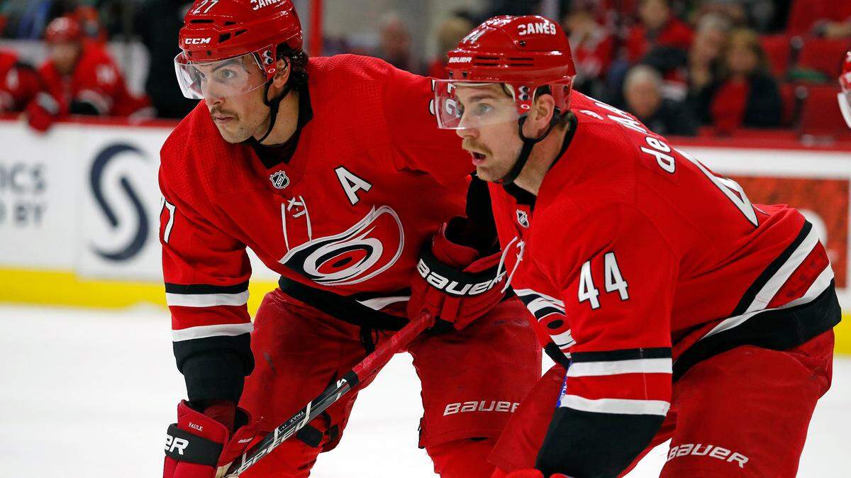 Carolina Hurricanes’ Justin Faulk (27) and Calvin de Haan (44) wait for a face off against the New Jersey Devils during the third period of an NHL hockey game, Sunday, Nov. 18, 2018, in Raleigh, N.C. (AP Photo/Karl B DeBlaker)