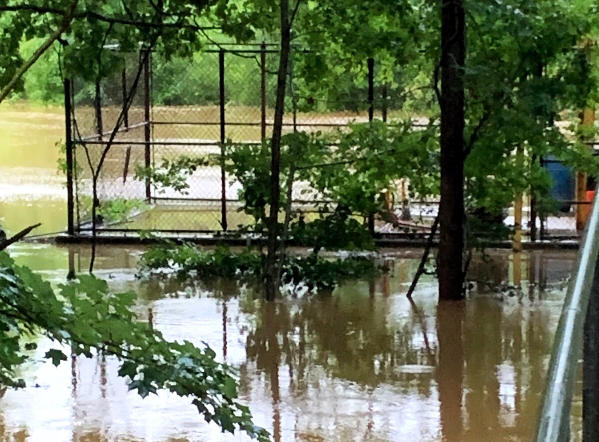 Eno River flood waters filled the raw sewage well, located inside the chain-link fence, at the Hillsborough River Pump Station on July 7, 2025. Millions of gallons of raw sewage was released into the river.