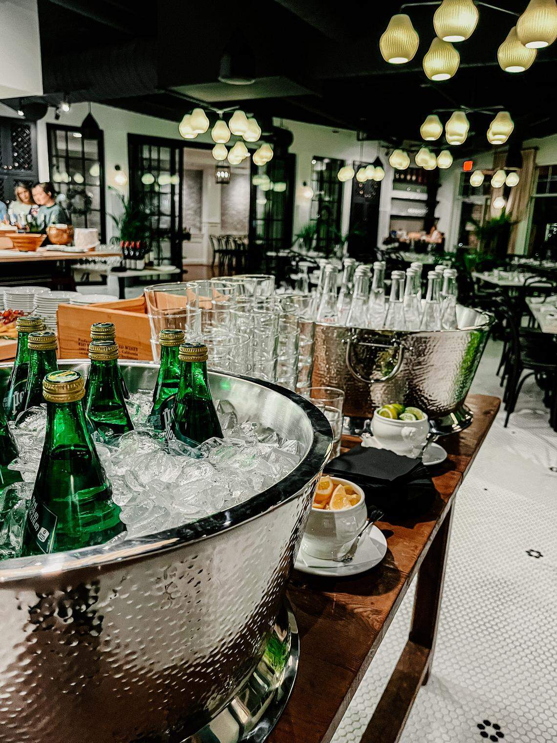 The dining room of Bluebird aims for elegance you can live in, with white tiled floors and a copper bartop.