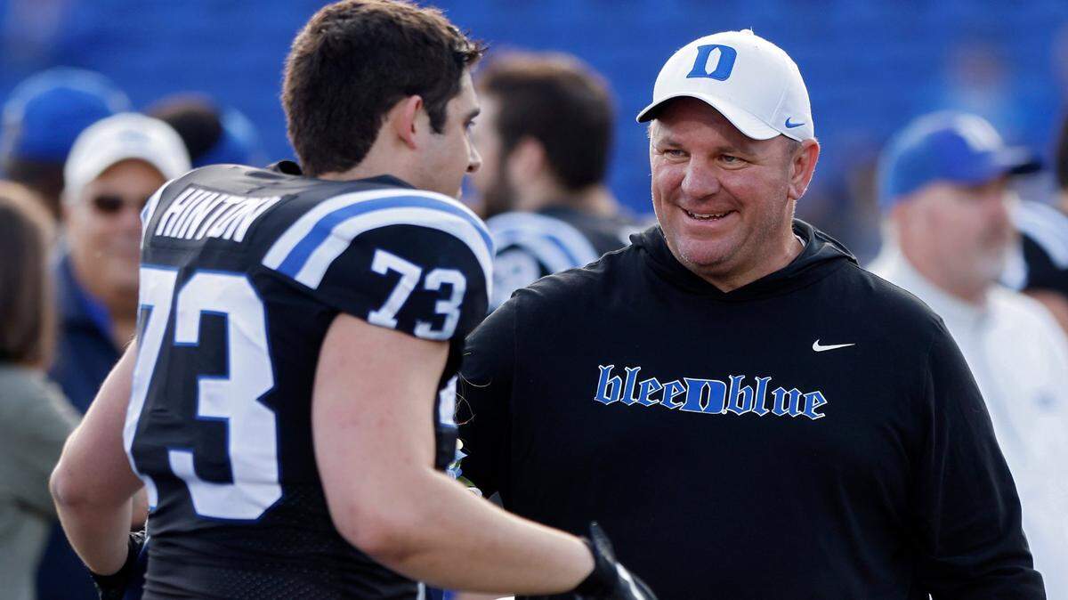 Duke head coach Mike Elko congratulates Anthony Hinton during a Senior Day ceremony prior to the Blue Devils’ final regular season game at Wallace Wade Stadium on Saturday, Nov. 26, 2022, in Durham, N.C.