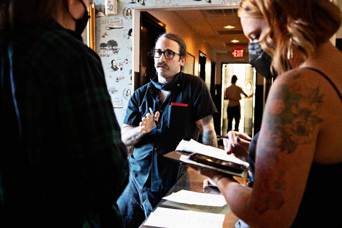 St. Roch’s chef and owner, Sunny Gerhart, center, meets with staff on Friday evening, Sept. 24, 2021, to go over the menu after reopening the downtown Raleigh restaurant.