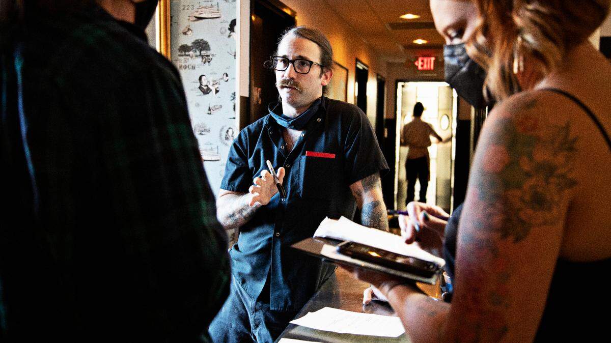 St. Roch’s chef and owner, Sunny Gerhart, center, meets with staff on Friday evening, Sept. 24, 2021, to go over the menu after reopening the Raleigh restaurant.