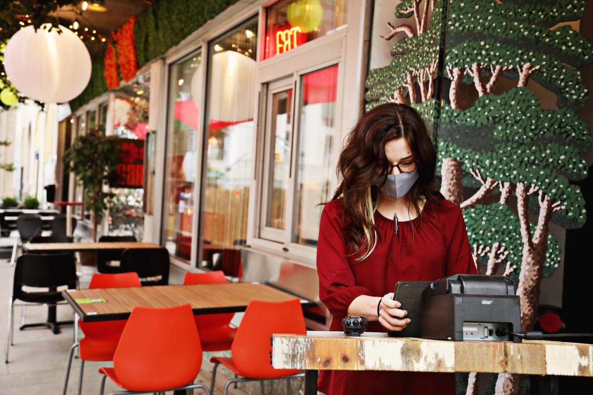 Garland general manager Allee Robertson prepares for dinner service in the new outdoor seating area at Garland in downtown Raleigh, Thursday, Sept. 24, 2020.