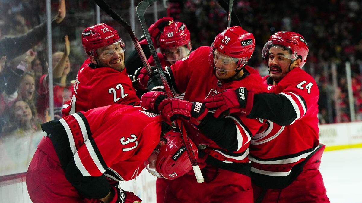 Nov 26, 2023; Raleigh, North Carolina, USA; Carolina Hurricanes right wing Andrei Svechnikov (37) is congratulated by center Sebastian Aho (20) defenseman Brett Pesce (22), center Seth Jarvis (24), and defenseman Brady Skjei (76) after his goal against the Columbus Blue Jackets during the third period at PNC Arena. Mandatory Credit: James Guillory-USA TODAY Sports