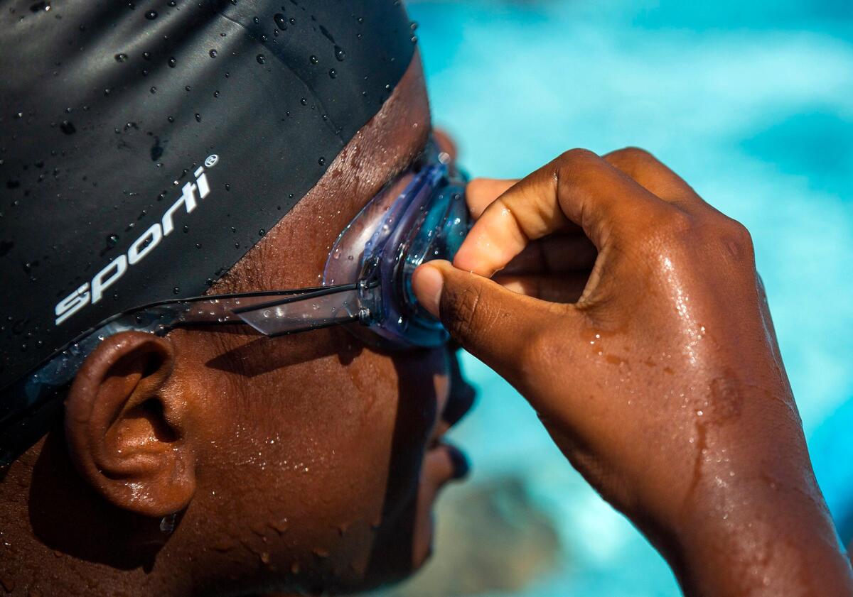 Khristian Short, 10, adjusts his goggles during a swim lesson with fellow 5th grade students taught by YMCA swim instructors at Southeast Raleigh Elementary School on Wednesday, Sep. 18, 2019, in Raleigh, NC. The school opened in August and features a wide range of partnerships, including the YMCA facilities.