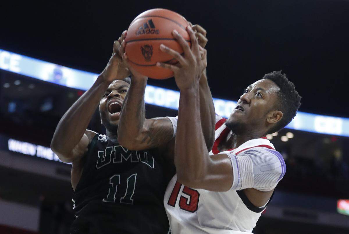 N.C. State’s Manny Bates (15) pulls the rebound from Mount Olive’s Johnny Hughes (11) during the second half of N.C. State’s 113-73 exhibition victory over Mount Olive at PNC Arena in Raleigh, N.C., Sunday, Oct. 27, 2019.
