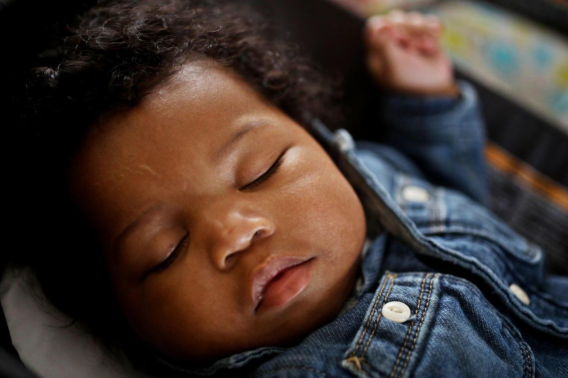 Jessica Murrell Berryman’s third child, Richard, naps as she works remotely from the family’s Durham home Dec. 6, 2019. Berryman enrolled in Medicaid for a short time when she had her first child right after college.