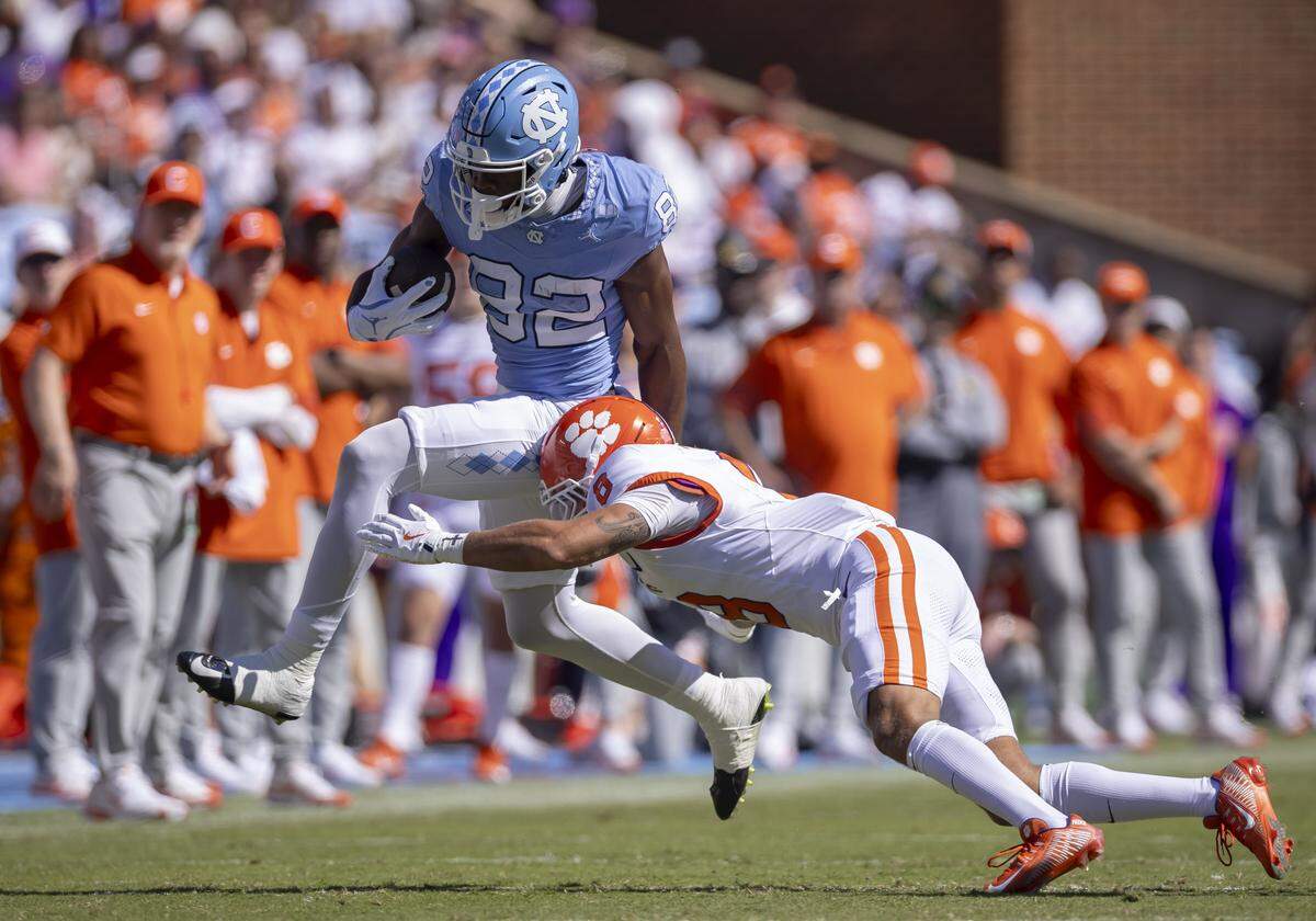 North Carolina wide receiver Nathan Leacock (82) is stopped by Clemson cornerback Avieon Terrell (8) in the third quarter on Saturday, October 4, 2025 at Kenan Stadium in Chapel Hill, N.C. 