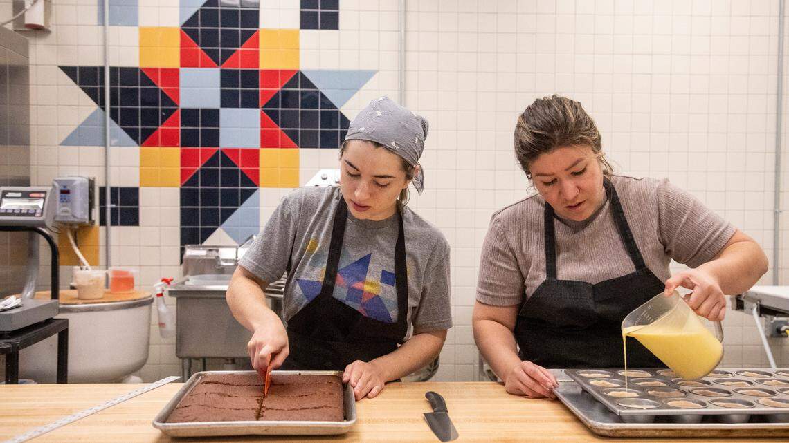 Sofia Vasquez, left, and Birdie Rojas prepare brownies and pastéis de nata as workers ready for he reopening of Boulted Bread at their new location on Dupont Circle in Raleigh on Friday, May 12, 2023.