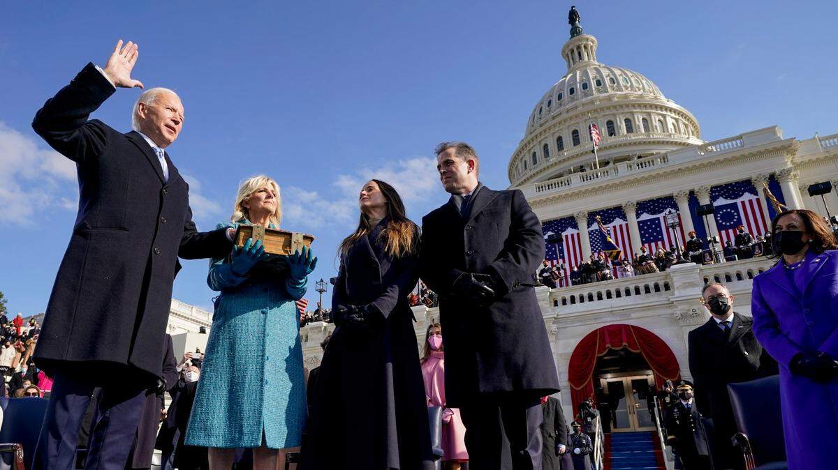 Joe Biden is sworn in as the 46th president of the United States by Chief Justice John Roberts as Jill Biden holds the Bible during the 59th Presidential Inauguration at the U.S. Capitol in Washington, Wednesday, Jan. 20, 2021, as their children Ashley and Hunter watch.