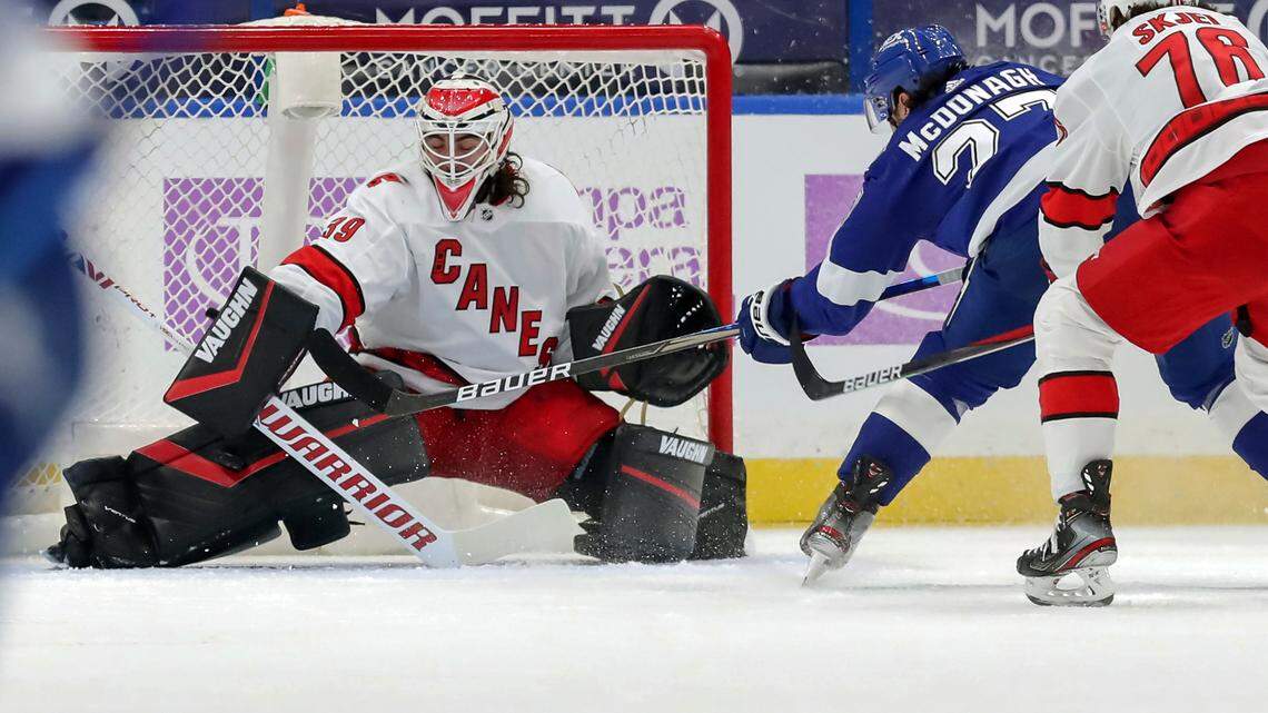 Carolina Hurricanes goaltender Alex Nedeljkovic makes a pad save on a shot from Tampa Bay Lightning’s Ryan McDonagh as Steven Lorentz (78) defends during the first period of an NHL hockey game Tuesday, April 20, 2021, in Tampa, Fla. (AP Photo/Mike Carlson)