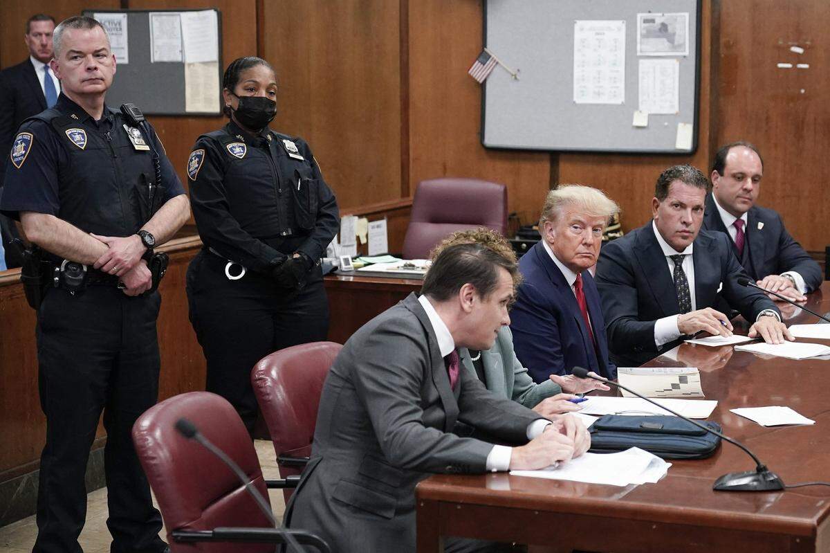 Flanked by attorneys, former U.S. President Donald Trump appears in the courtroom for his arraignment proceeding at Manhattan Criminal Court on Tuesday, April 4, 2023, in New York City.