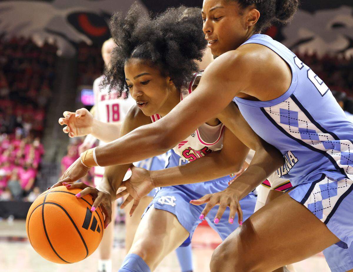 N.C. State’s Qadence Samuels and North Carolina’s Indya Nivar battle for possession during the second half of the Wolfpack’s 61-59 loss on Monday, Feb. 2, 2026, at Reynolds Coliseum in Raleigh, N.C.