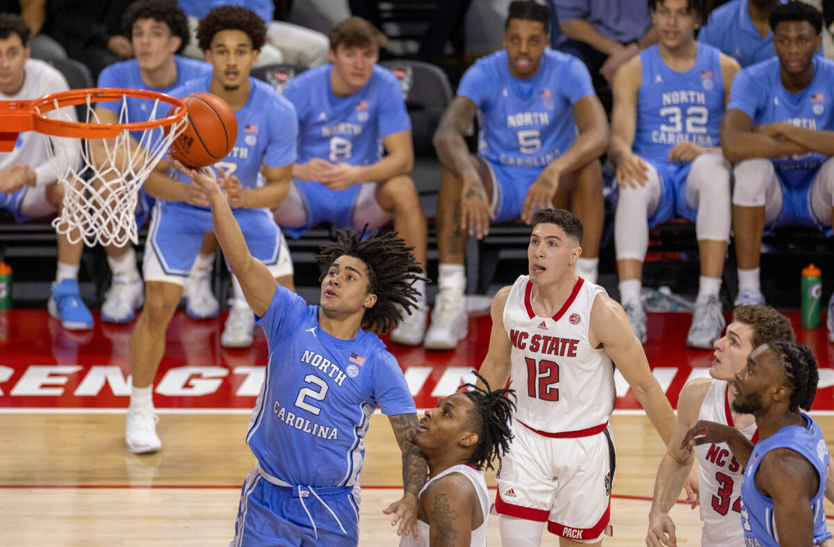 North Carolina’s Elliot Cadeau (2) drives to the basket against N.C. State’s MJ Rice (3) in the second half on Wednesday, January 10, 2024 at PNC Arena in Raleigh, N.C. Cadeau scored 11 points in the Tar Heels’ victory.