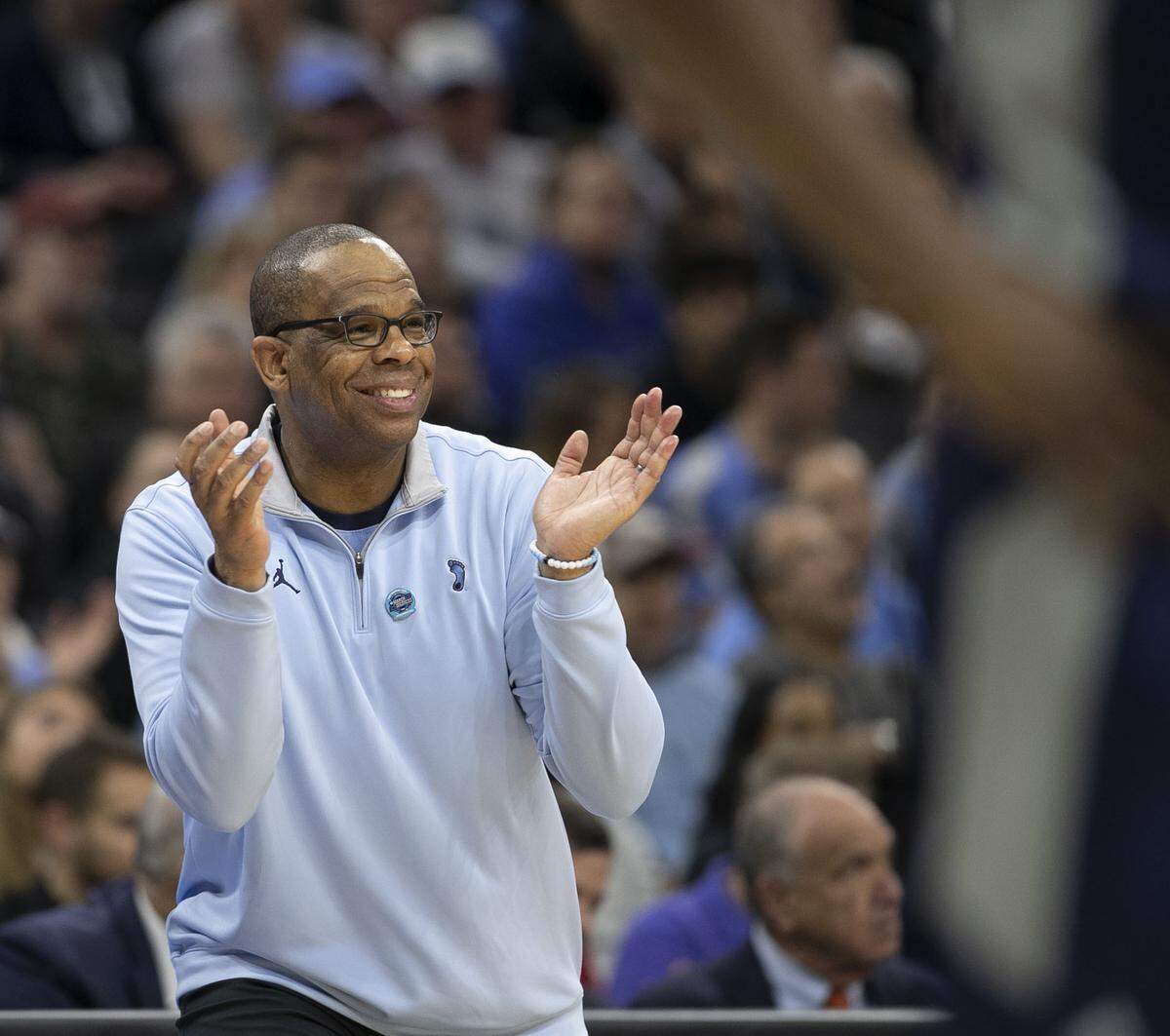 North Carolina coach Hubert Davis smiles as he applauds his team’s performance late in the second half against Saint Peter’s during of the NCAA East Regional final on Sunday, March 27, 2022 at Wells Fargo Center in Philadelphia, Pa.